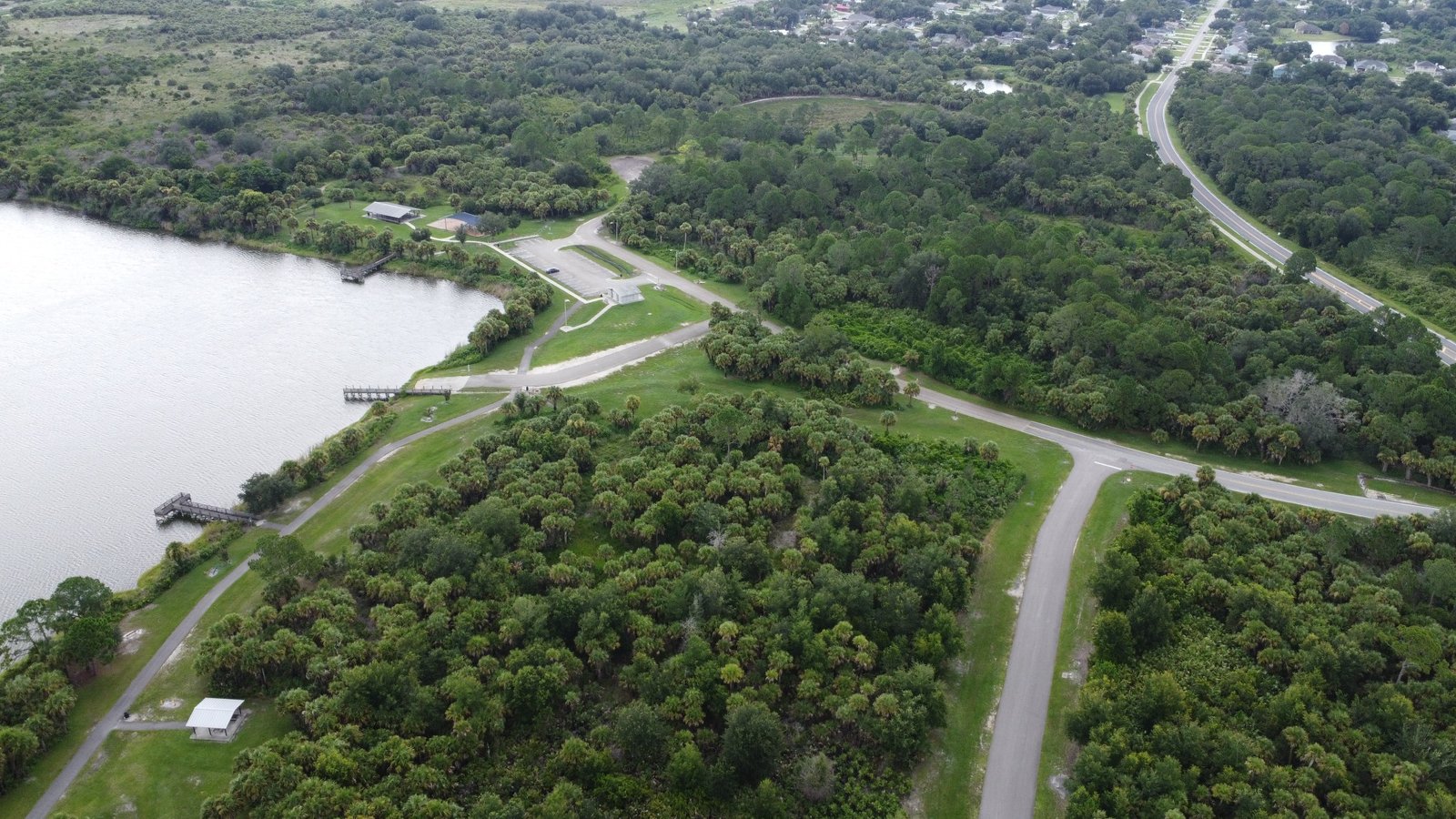 Aerial view of the shoreline, trails, and wooded landscape at Fay Lake Wilderness Park