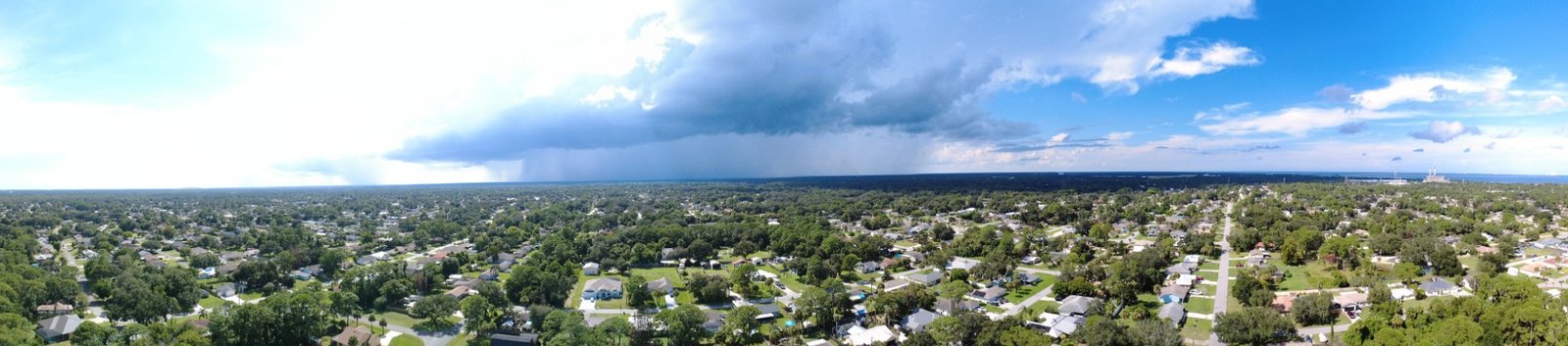 Panoramic aerial view of a late afternoon storm over Port St. John and the Space Coast